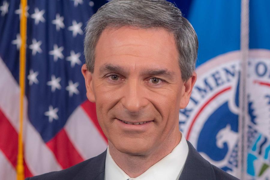Formal portrait of Ken Cuccinelli in front of the US and Department of Homeland Security flags
